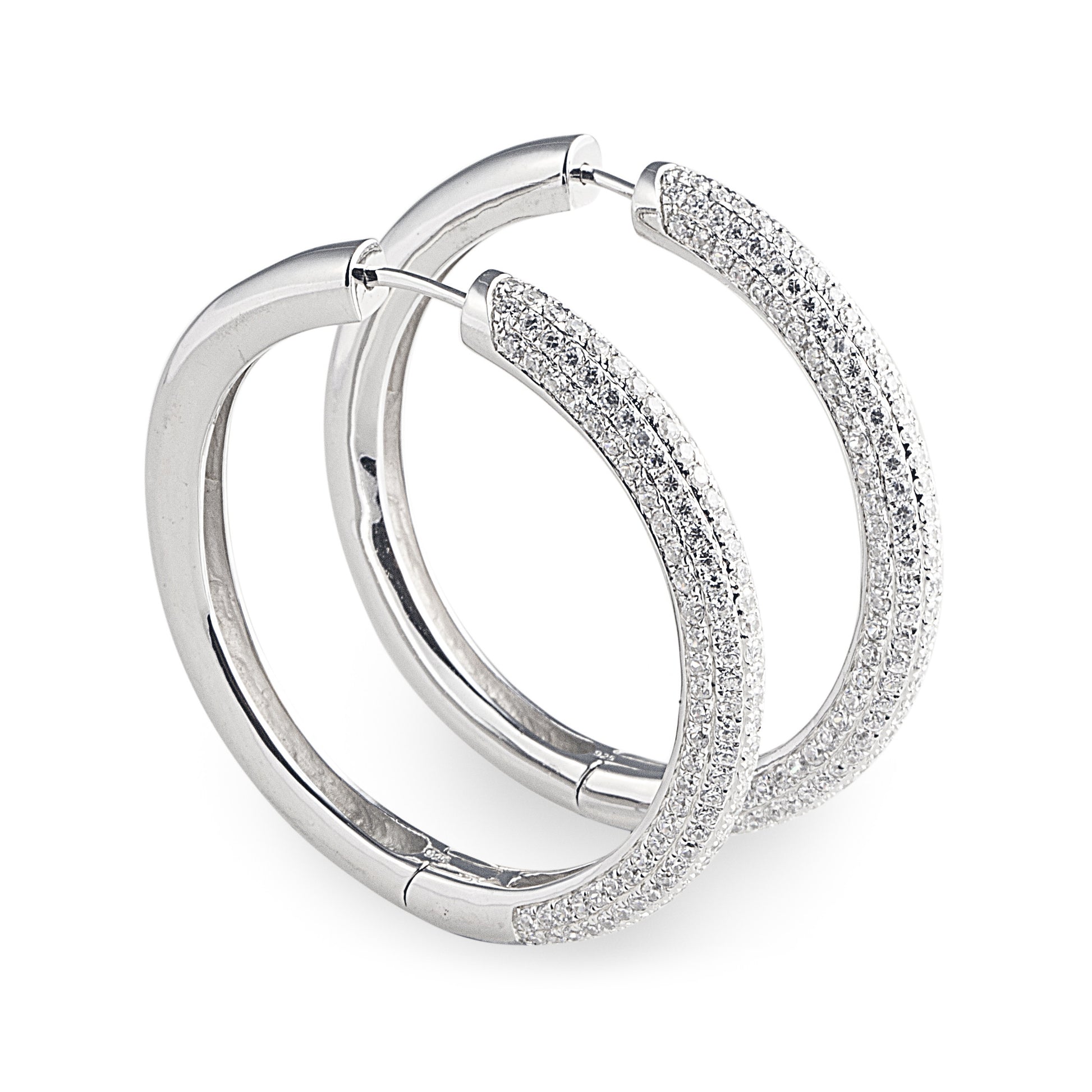 large-sized J-Lo Hoop Earrings in 925 Sterling Silver with 9ct white gold posts, featuring pavé set cubic zirconia stones. Worldwide Shipping. Affordable luxury jewellery by Bellagio & Co.