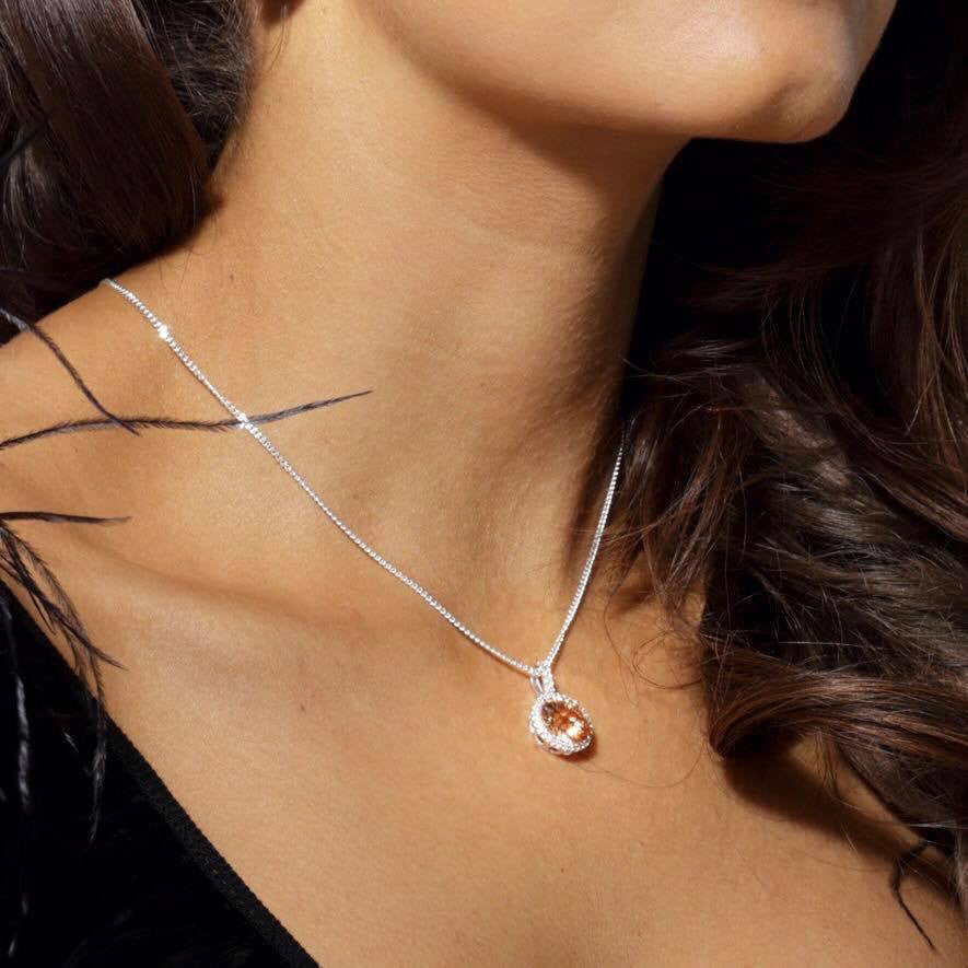 The Empire Necklace is a hanging antique style 925 sterling silver necklace featuring a large regal champagne cubic zirconia stone. Worldwide shipping.