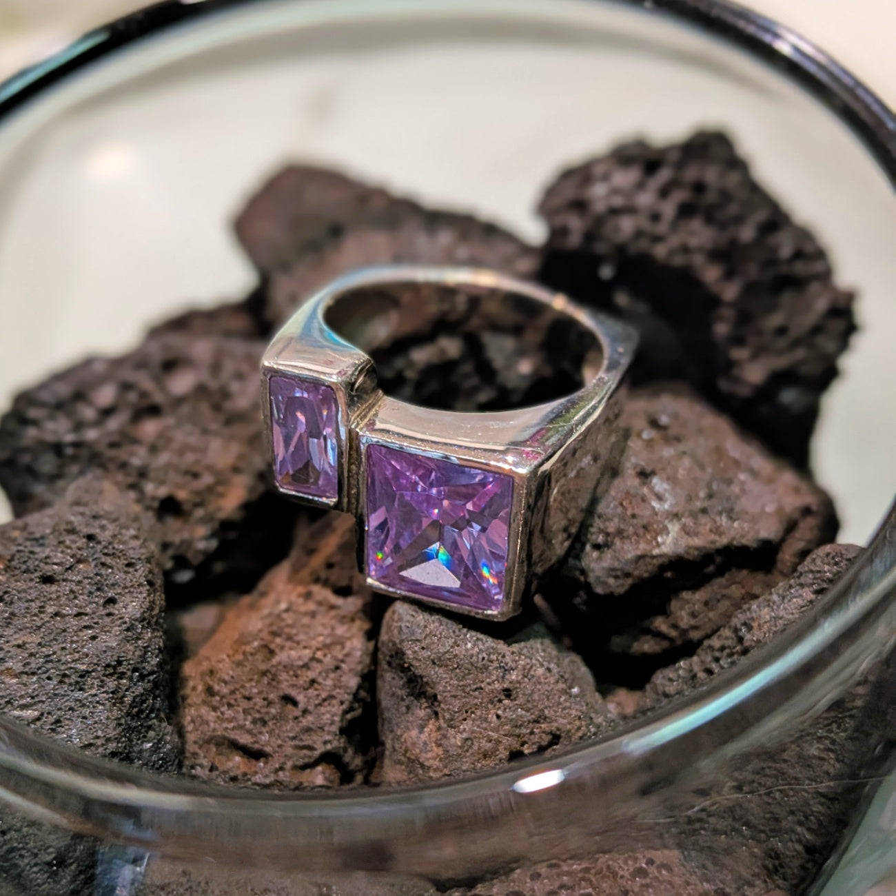 Amalfi Ring in 925 Sterling Silver featuring two purple princess cut stones set into a modern asymmetric design. Worldwide shipping. Jewellery by Bellagio & Co.