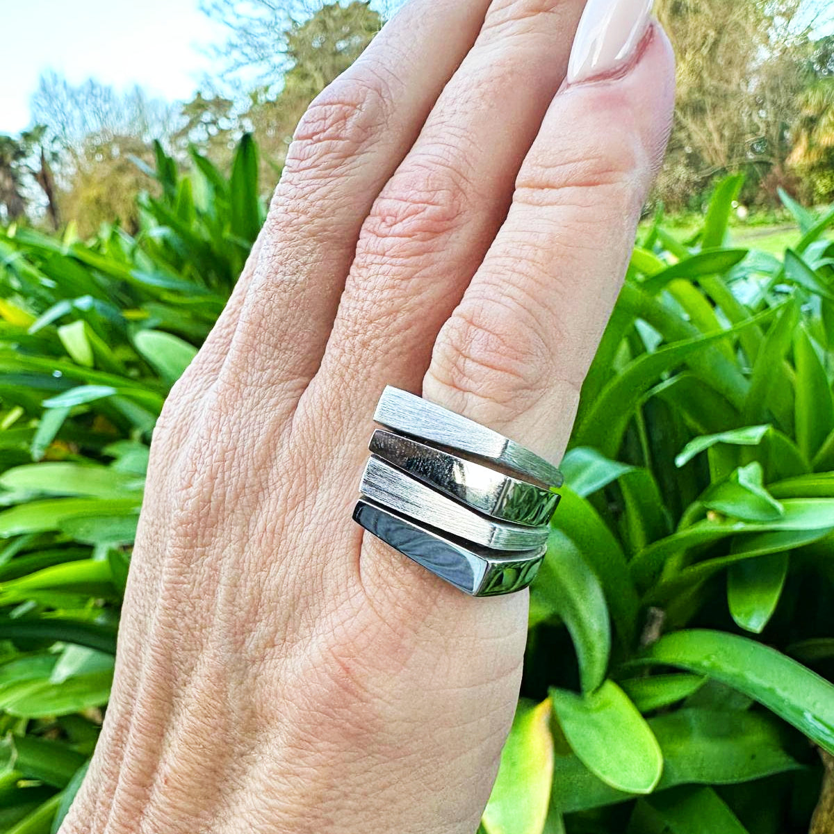 Charmed Ring. Joined stack of 925 Sterling Silver rings. Two rings are polished and two are brushed to give texture and contrast. Worldwide shipping. Affordable luxury jewellery by Bellagio & Co.