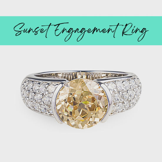 Sunset Engagement Ring in 925 sterling silver with a large facet cut champagne cubic zirconia centre stone surrounded by smaller classic clear cubic zirconia stones in a pavé setting. Shop rings and luxury jewellery at affordable prices by Bellagio & Co. Designed in Australia. Worldwide Shipping